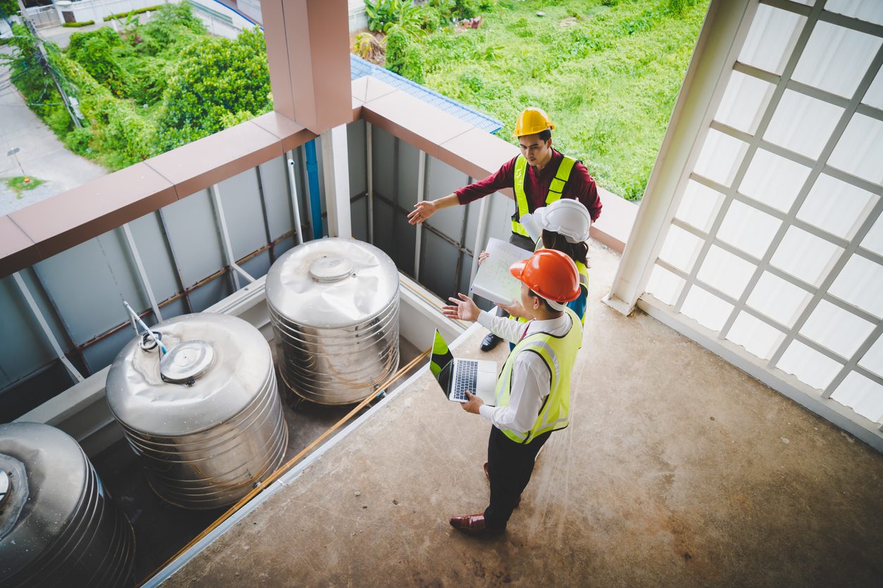 Three contractor engineer and worker discussing transitioning to a smart meter infrastructure